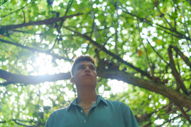istock Portrait of young man in tropical forest 1465457788