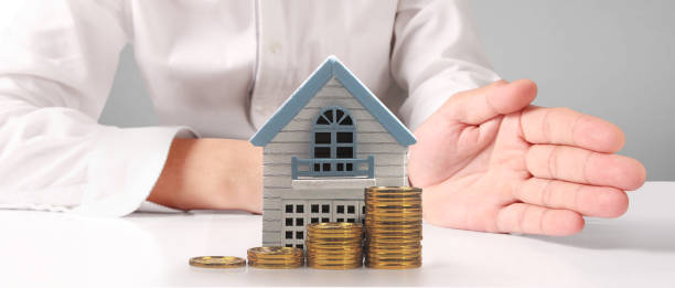 istock House Residential Structure in hand ,model house and coin 1465458167