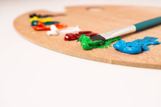 istock wooden palette with colored oil paint and brushes 1465460247
