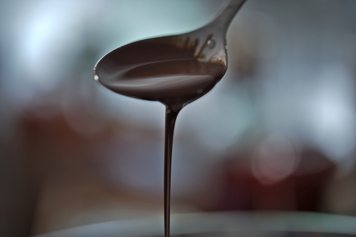 Melted chocolate dropping from a spoon