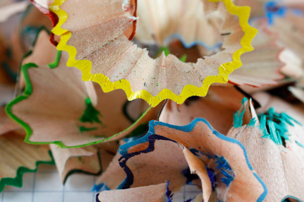 A pile of shavings from sharpening colored pencils now lies on the checkered paper and simply can be used as a creative background