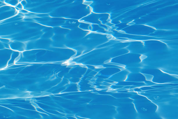istock Defocus blurred transparent blue colored clear calm water surface texture with splashes and bubbles. Trendy abstract nature background. Water waves in sunlight with copy space. Blue watercolor shining 1465463533