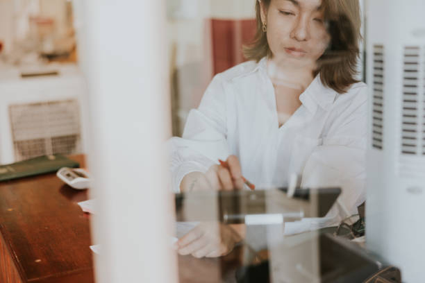 istock Working and Calculating for her shop data account 1465464343