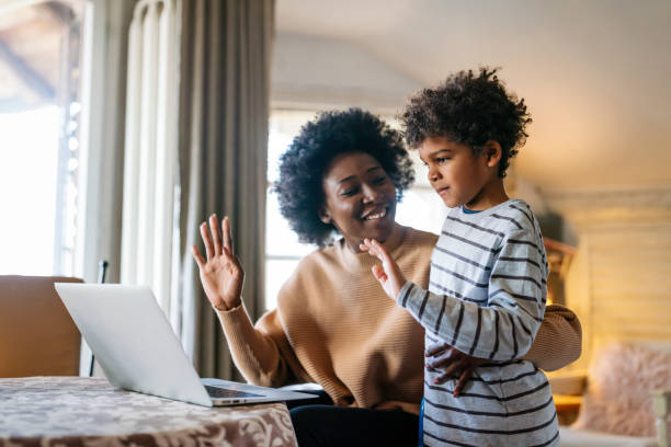istock Happy black family gathering around notebbok and having fun during a video call 1465465584
