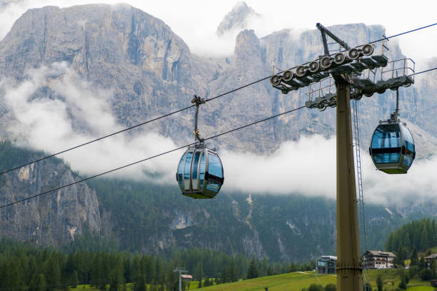 istock Two cable way cabins against the Dolomites covered with clouds 1465466639