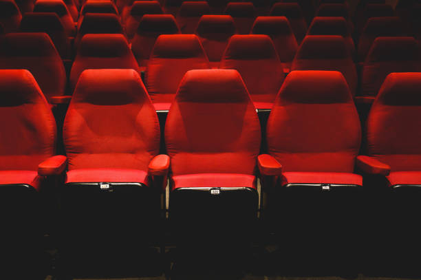istock Interiors of empty comfortable red cinema chairs. Low-key. Dark tone. 1465467055