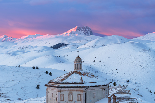 Winter close- up view of the church of Santa Maria della Pietà covered with snow at sunset, Rocca Calascio, Gran Sasso e Monti della Laga National Park, L'Aquila, Abruzzo, Apennines, Italy