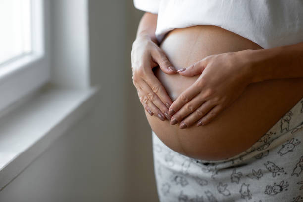 istock Make heart sign on pregnant belly 1465468280