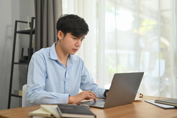 istock Concentrated asian male working on commercial and marketing project at modern home office. 1465469607