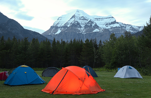 View of camping tents against snowcapped in Mount Robson Provincial Park, British Columbia, Canada.