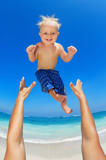 istock Father throwing up in the air a happy child 1465474431