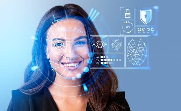 Smiling businesswoman watching at digital interface with facial recognition stock photo