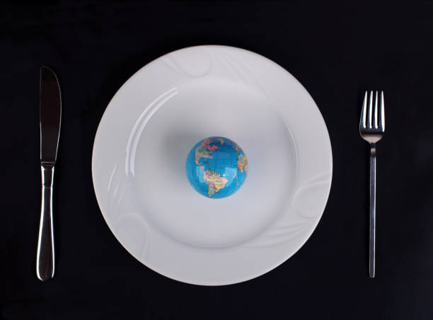 istock Earth served on plate with fork and knife. Consumerism concept. 1465476245