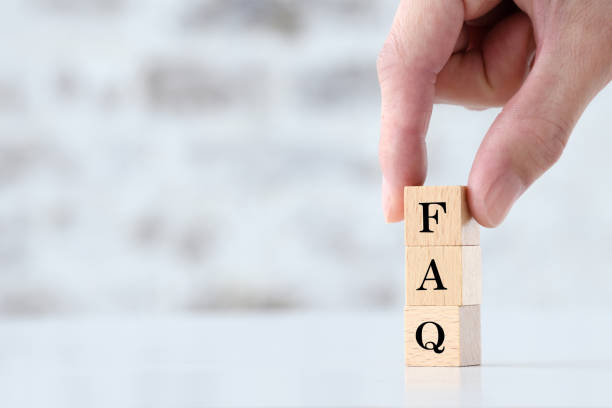 istock Human's hand picking wooden blocks with FAQ word 1465478251