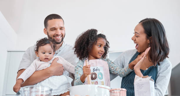 istock Family, cooking and learning with high five for success from supportive mother in home kitchen. Teamwork, achievement and happy parents proud of baker skills of child mixing cake ingredients. 1465480591