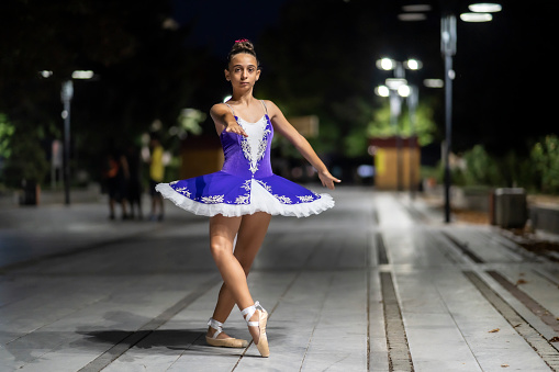 Ballerina poses on the city streets.