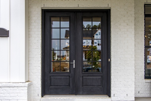 A front porch with a red door