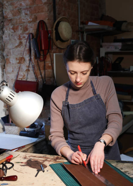 istock young brunette woman works in a bag making studio 1465485134