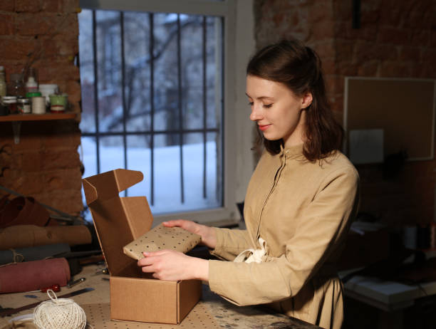 istock woman folds packing box in sewing workshop 1465485154
