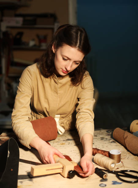 istock young brunette woman works in a bag making studio 1465485189