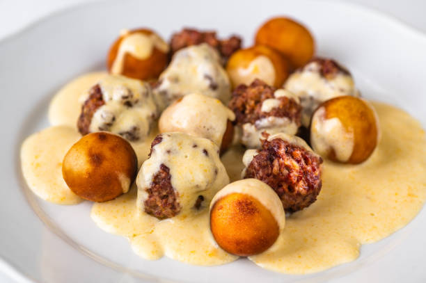 Meatball with fried croquette in lemon sauce, stock photo