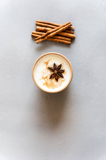Chai latte with star anise and cinnamon Black tea, spice, top view, gray background, hot drink, milk foam ayurveda cardamom star anise spice stock pictures, royalty-free photos & images