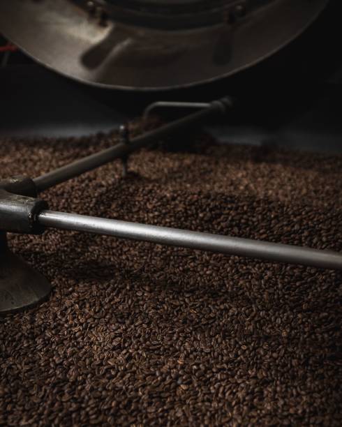 istock Vertical closeup of the coffee beans in a coffee roasting machine in a roastery 1465485857
