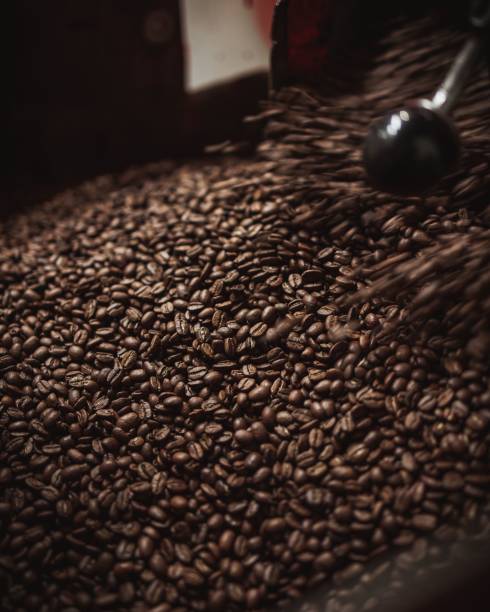 istock Vertical closeup of the coffee beans in a coffee roasting machine in a roastery 1465485923