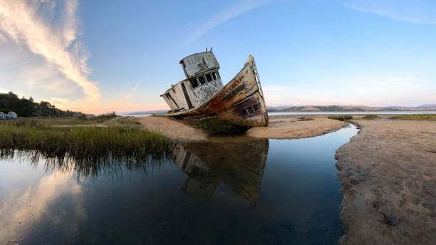 istock Rusty old boat on the coast with reflected on water 1465488300