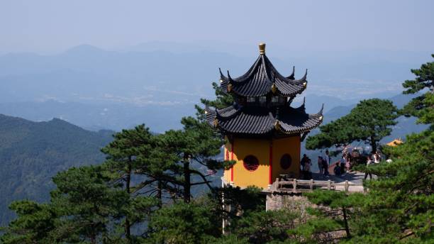 istock Chinese-styled temple on a mountain peak surrounded by trees 1465488560