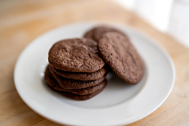 A plate of chocolate chip cookies  on wooden table