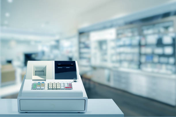 Electronic cash register has backdrop of a pharmacy store. Cash register Electronics the counter in a pharmacy till stock pictures, royalty-free photos & images