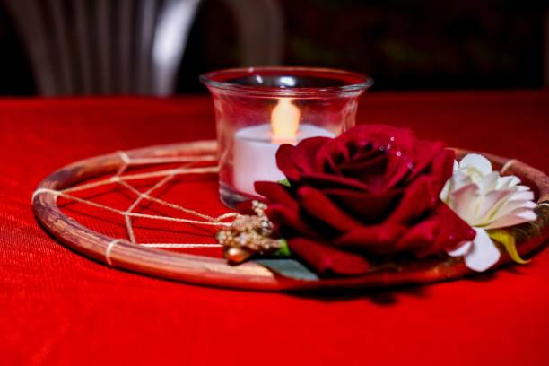 istock Candle and flowers on red tablecloth 1465490387