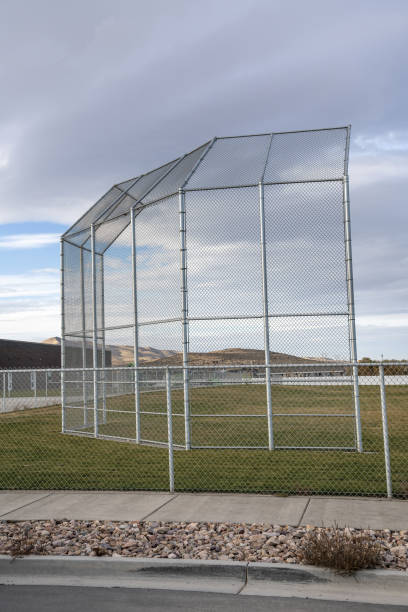 istock Vertical shot of baseball backstop under the cloudy sky 1465490481