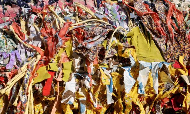 istock Strips of cut old cloth of different colors. Full frame 1465491930