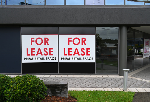 Commercial property for lease with two big signs on the window