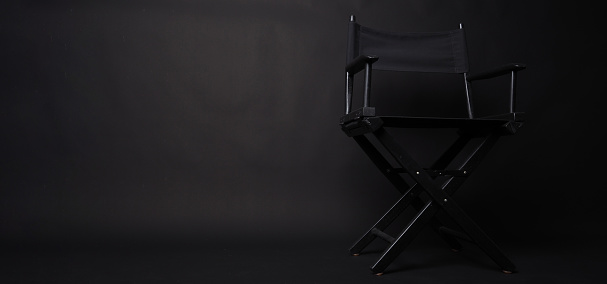 Black Director chair on black blackground.