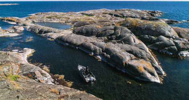 istock Boat rocky island 1465497265