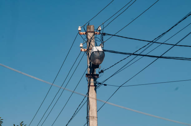 istock A lamp post with a lantern and wires on a blue sky background 1465497931