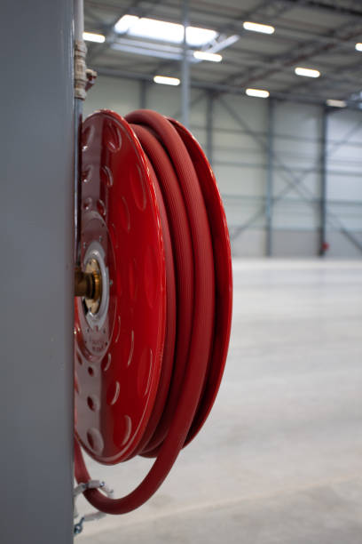 istock Vertical shot of a fire hose in a warehouse 1465498582