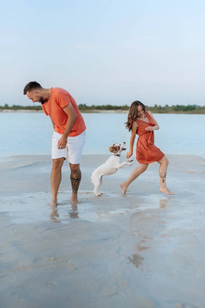 istock young couple in orange clothes with dog 1465498693