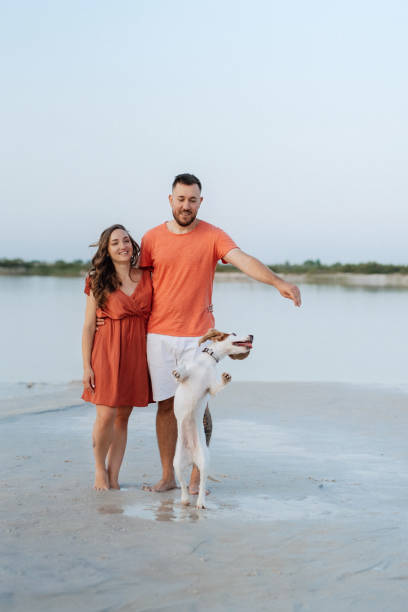 istock young couple in orange clothes with dog 1465499622