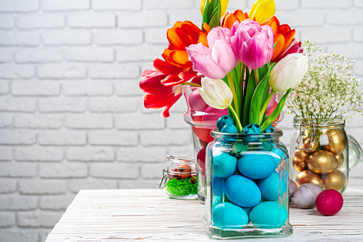 Easter decoration. Flower bouquet with colored eggs