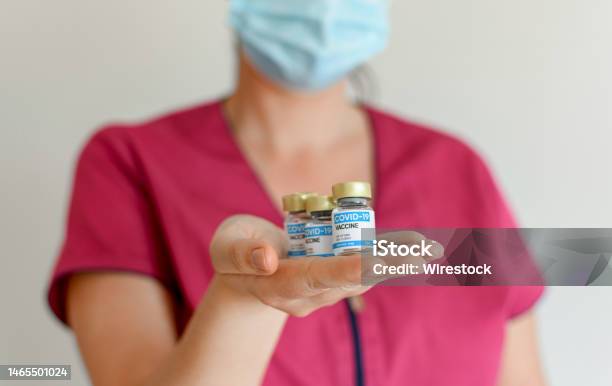 Closeup Image Of Doctor Holding Covid Vaccine Vials With Generic Logo Stock Photo - Download Image Now