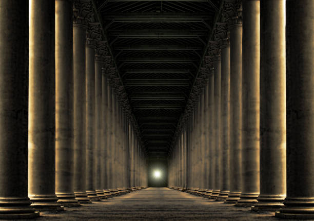 row of pillars at night with light at the end