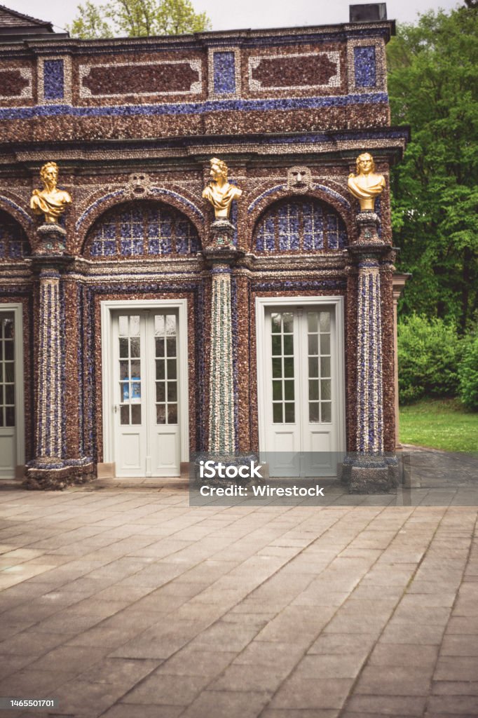 Vertical shot of a patterned building with columns and sculptures in Bayreuth - Eremitenhof A vertical shot of a patterned building with columns and sculptures in Bayreuth - Eremitenhof, St. Johannis Bayreuth Stock Photo