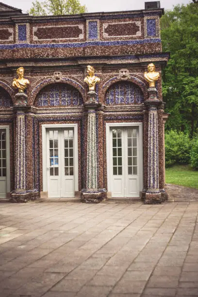 A vertical shot of a patterned building with columns and sculptures in Bayreuth - Eremitenhof, St. Johannis