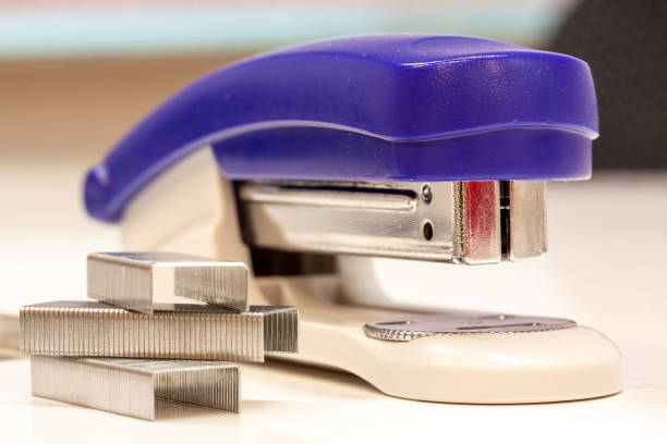 A closeup shot of a blue stapler on a white background