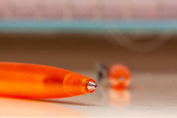 A closeup shot of yellow pens on a white surface