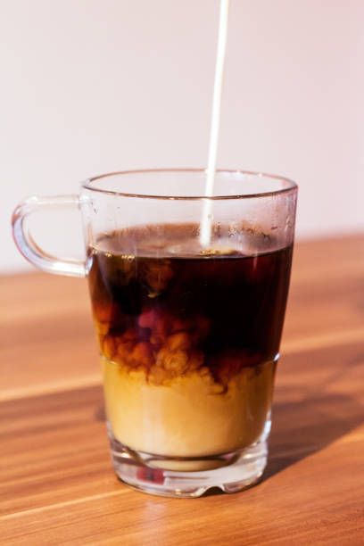 istock Milk poured in black coffee 1465503952